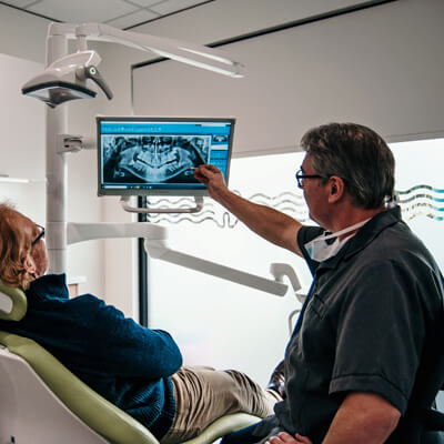 Dr Tony and patient reviewing x-rays